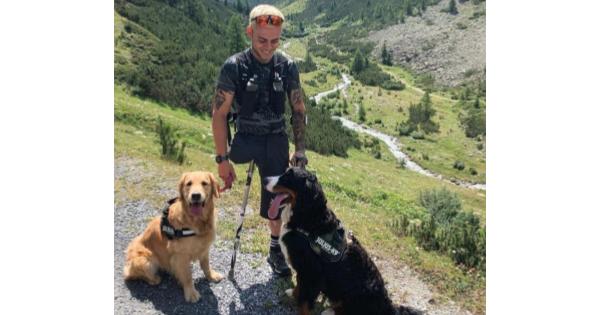 With Two Dogs By His Side, Paralympic Athlete Reaches New Heights